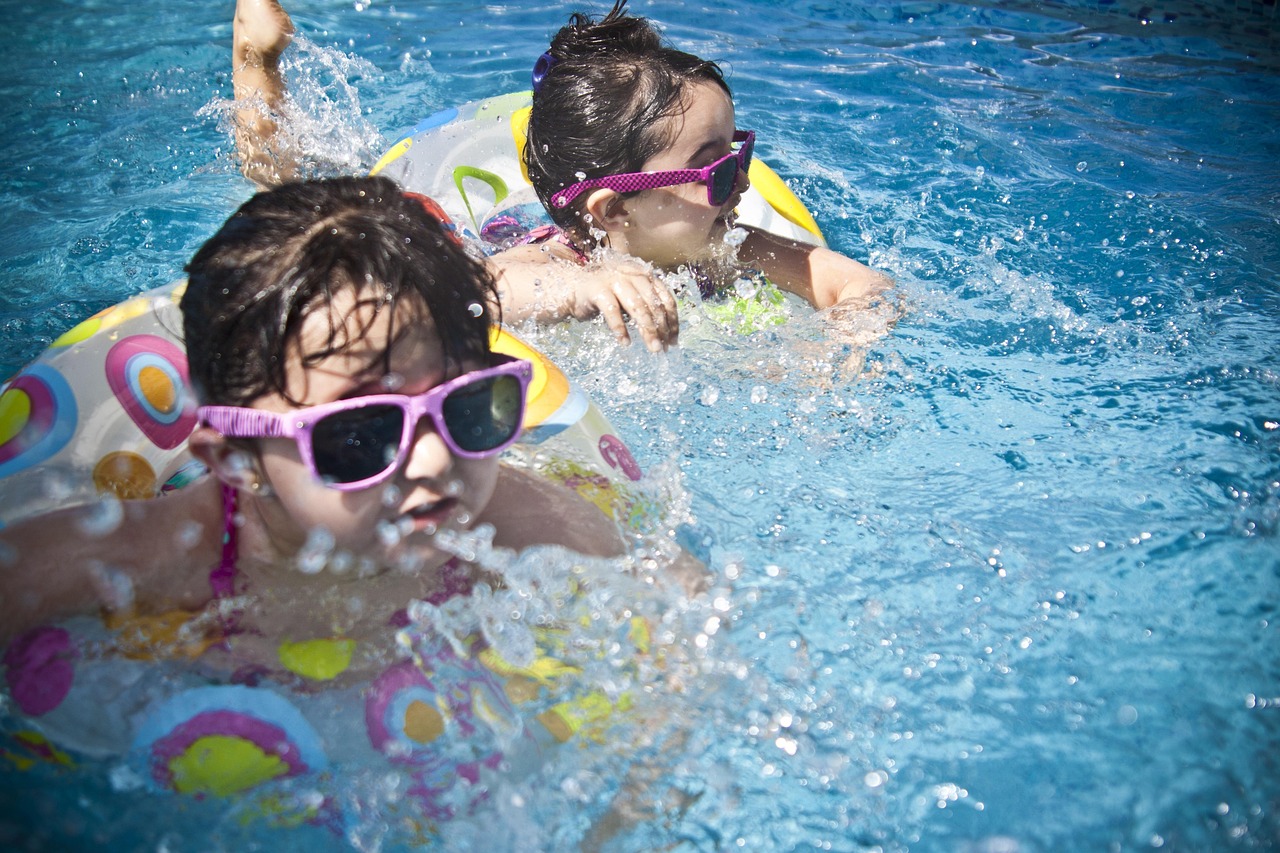 girls, swimming, splashing, sisters, little girls, floaters, swim, swimming pool, pool, summer, vacation, splashing water, childhood, children, kids, shades, sunglasses, people, water, cute, wet, young, happy, joy, nature, fun, activity, happiness